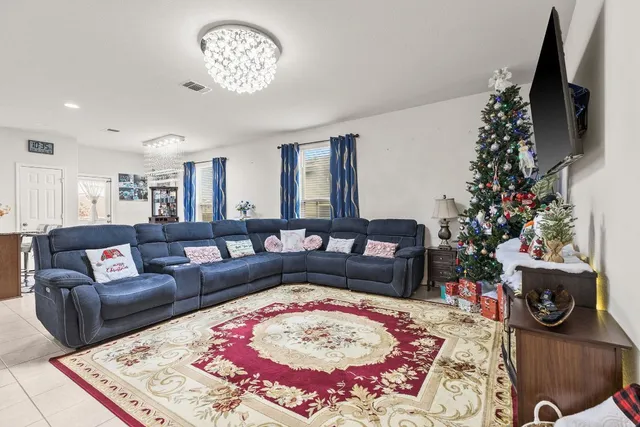 a living room with furniture and a christmas tree