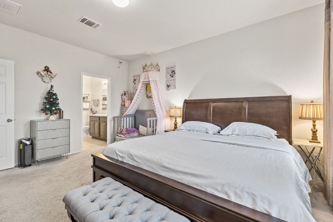 209 Ibis Falls Loop Jarrell, TX 76537 - Photo 5 of 40 a bedroom with a large bed and dresser