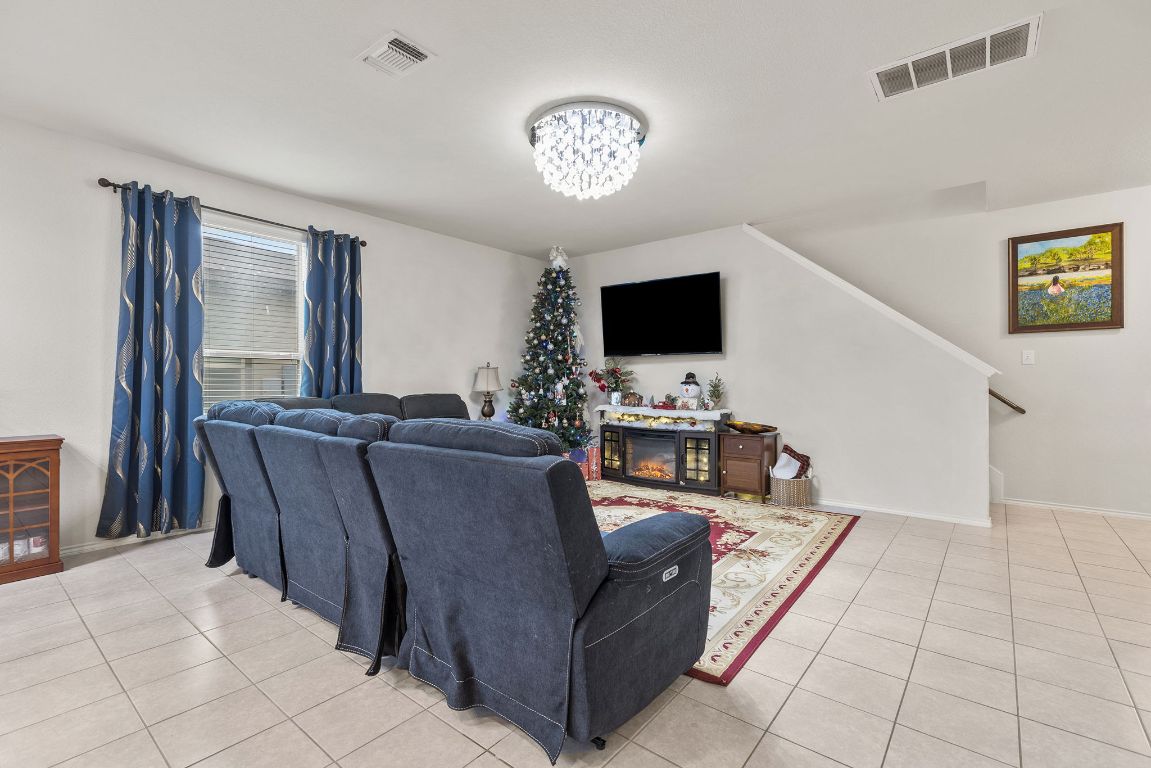209 Ibis Falls Loop Jarrell, TX 76537 - Photo 9 of 40 a living room with furniture and a flat screen tv