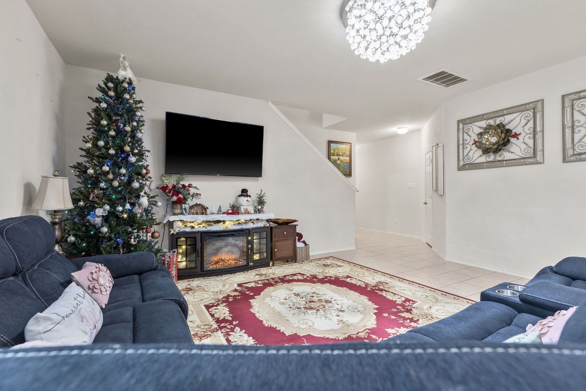 209 Ibis Falls Loop Jarrell, TX 76537 - Photo 10 of 40 a living room with furniture and a flat screen tv