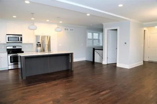 a kitchen with stainless steel appliances granite countertop a sink a stove and a refrigerator