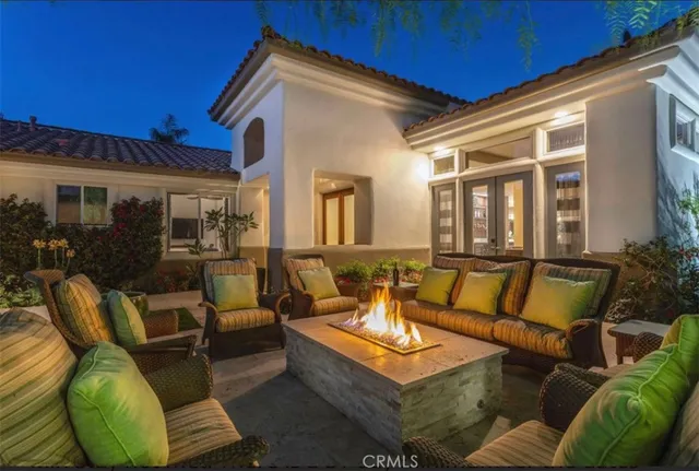 a view of a patio with couches table and chairs with wooden floor