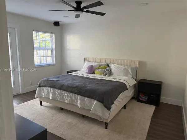 a bedroom with a bed and window