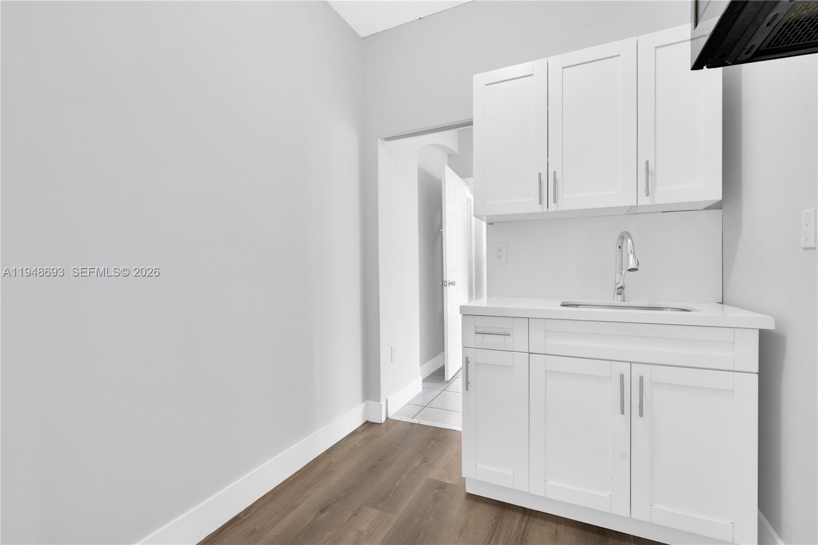 74 Northwest 2nd Street Homestead, FL 33030 - Photo 12 of 41 a view of cabinets with wooden floor