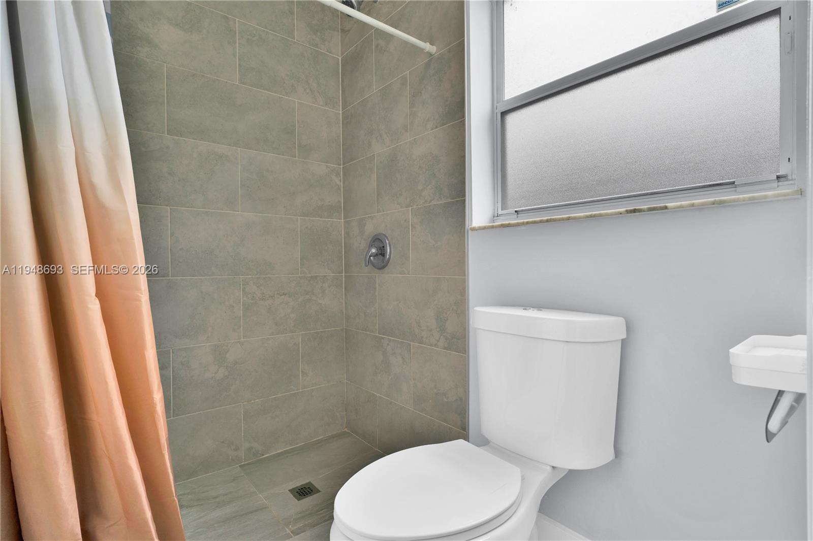 74 Northwest 2nd Street Homestead, FL 33030 - Photo 16 of 41 a white toilet sitting next to a bathroom sink