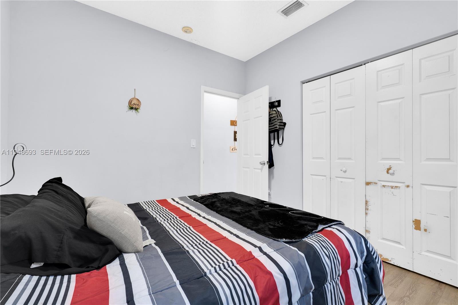 74 Northwest 2nd Street Homestead, FL 33030 - Photo 19 of 41 a bedroom with a bed and a painting on the wall