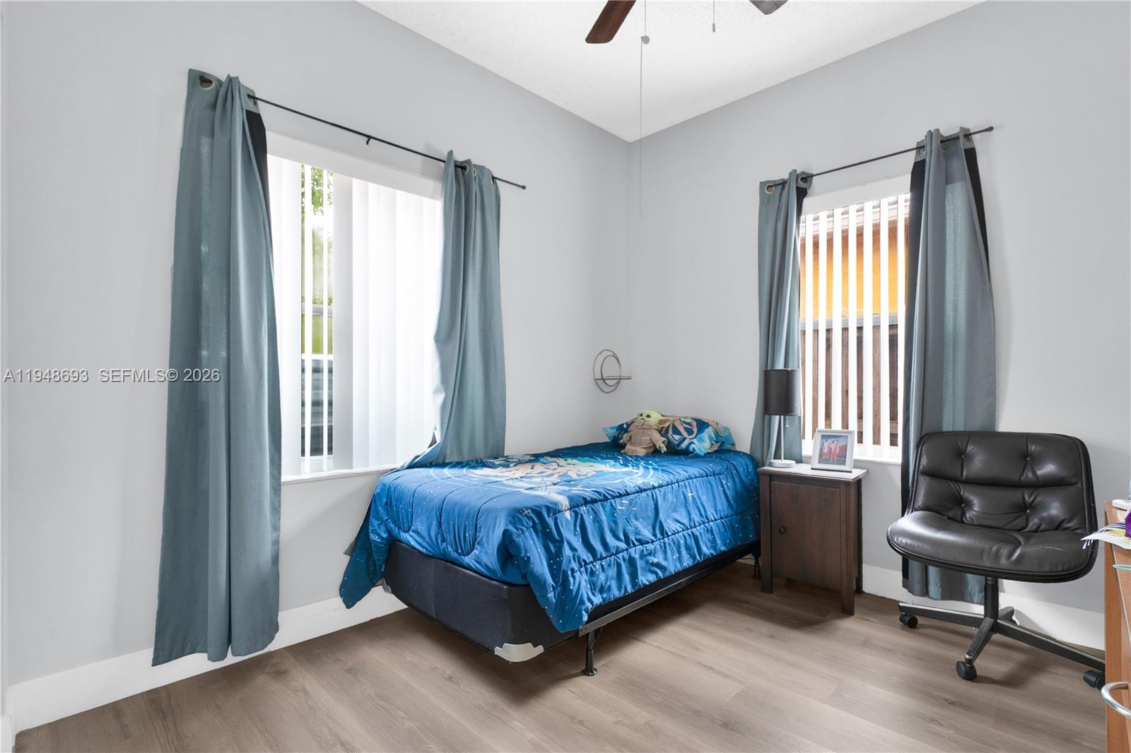 74 Northwest 2nd Street Homestead, FL 33030 - Photo 20 of 41 a bedroom with a bed and a chair