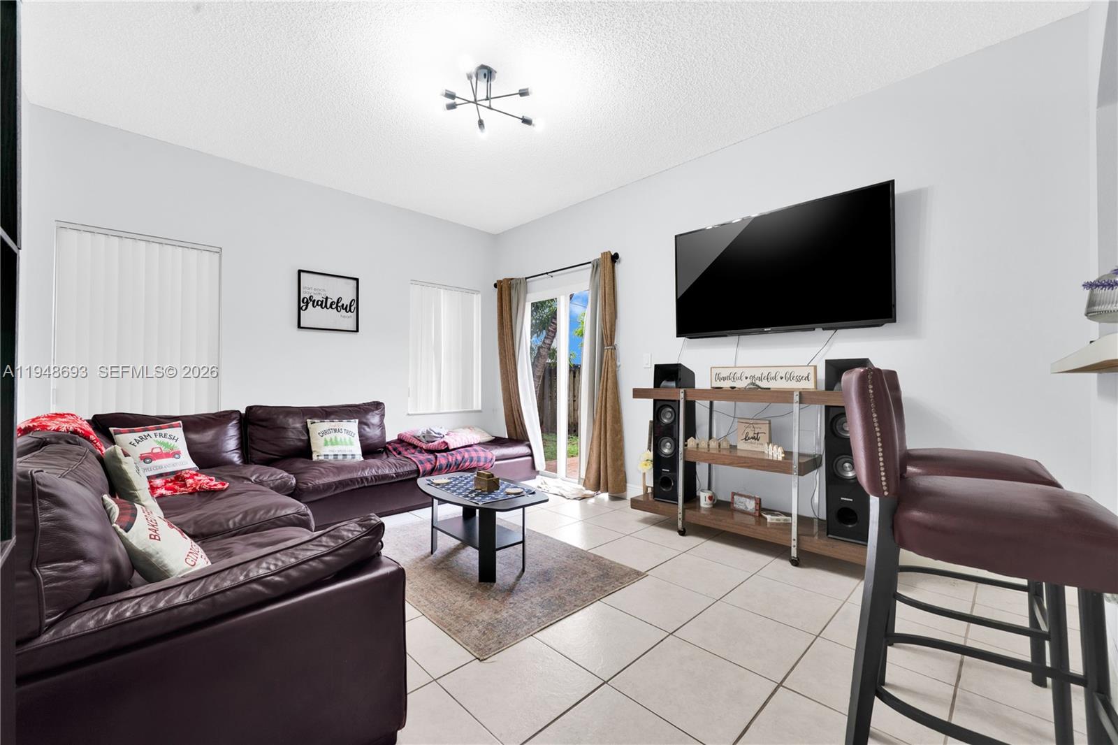 74 Northwest 2nd Street Homestead, FL 33030 - Photo 23 of 41 a living room with furniture and a flat screen tv