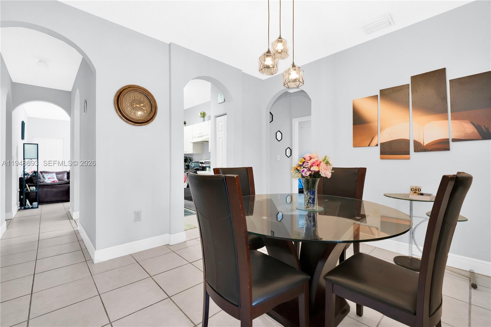 74 Northwest 2nd Street Homestead, FL 33030 - Photo 25 of 41 a view of a dining room and kitchen with a dining table and chairs