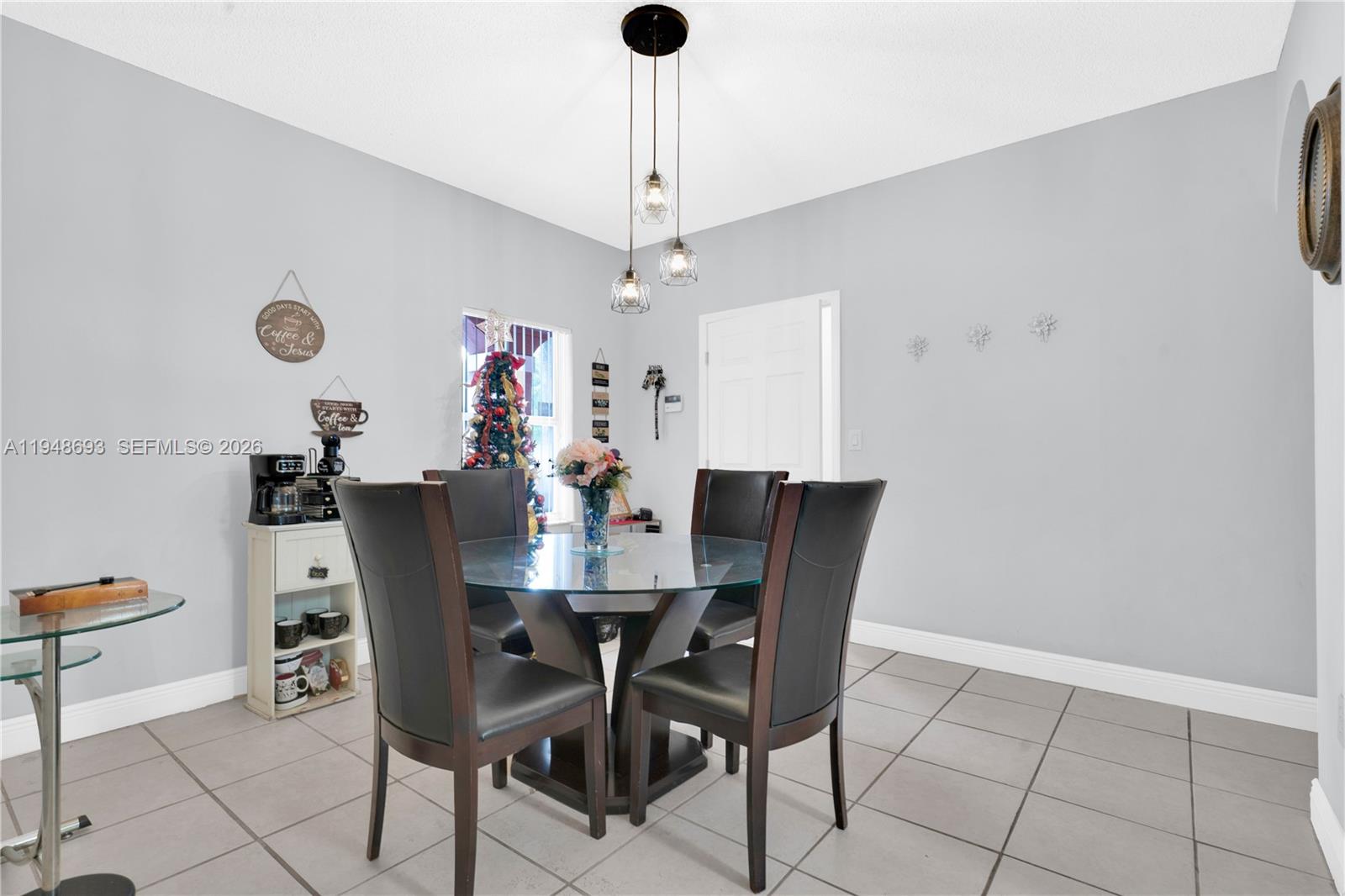 74 Northwest 2nd Street Homestead, FL 33030 - Photo 26 of 41 a view of a dining room with furniture and a chandelier fan
