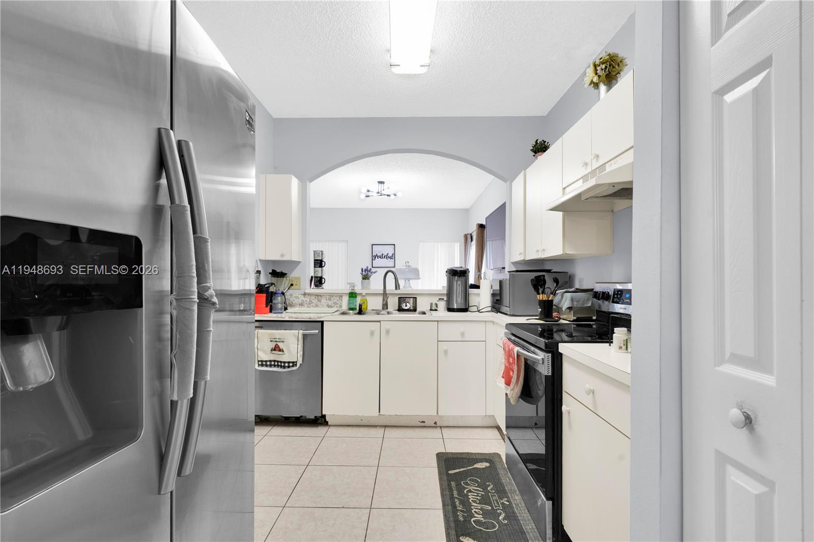 74 Northwest 2nd Street Homestead, FL 33030 - Photo 27 of 41 a kitchen with stainless steel appliances granite countertop a sink and a refrigerator