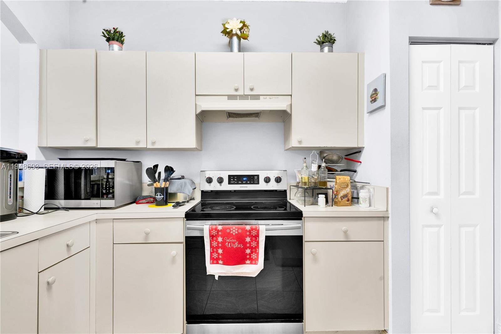 74 Northwest 2nd Street Homestead, FL 33030 - Photo 28 of 41 a kitchen with granite countertop a sink a stove and cabinets