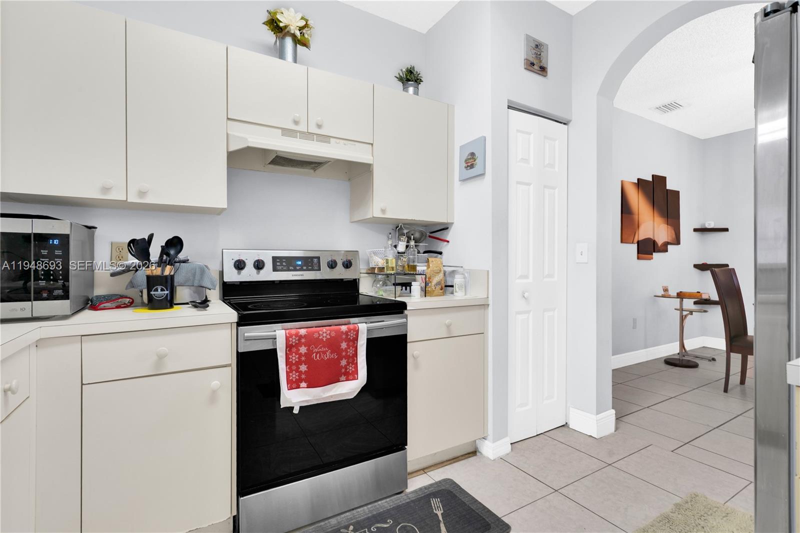 74 Northwest 2nd Street Homestead, FL 33030 - Photo 29 of 41 a kitchen with stainless steel appliances granite countertop a refrigerator a stove a sink and white cabinets