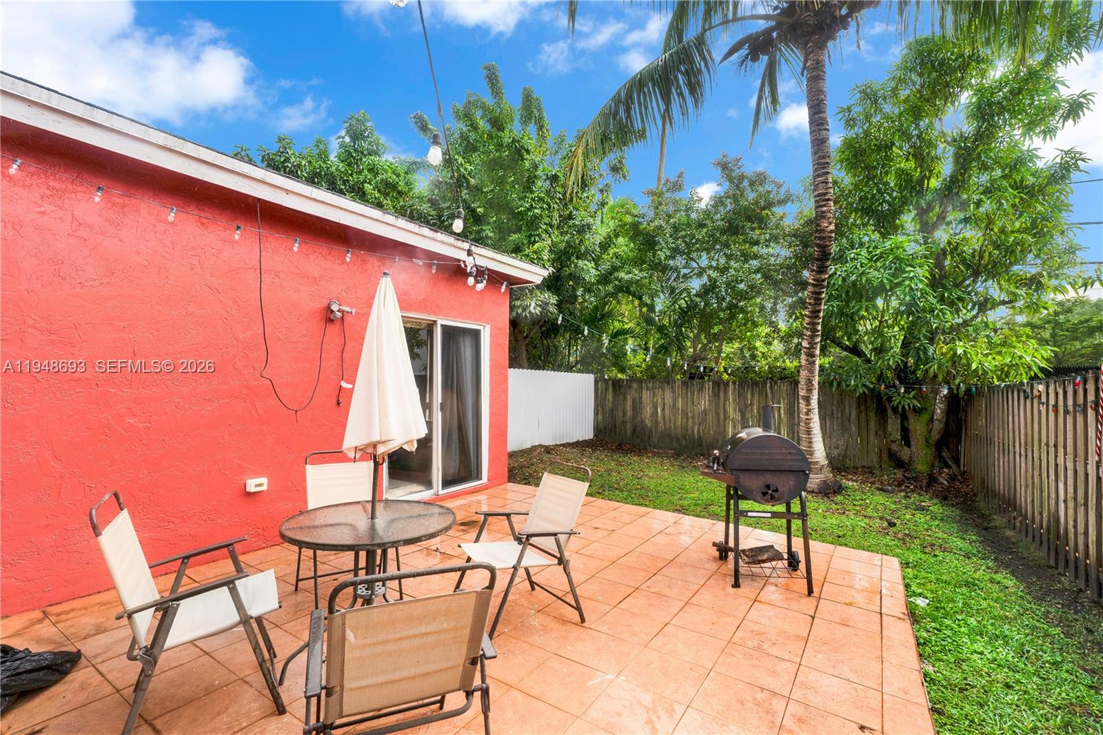 74 Northwest 2nd Street Homestead, FL 33030 - Photo 39 of 41 a backyard of a house with table and chairs