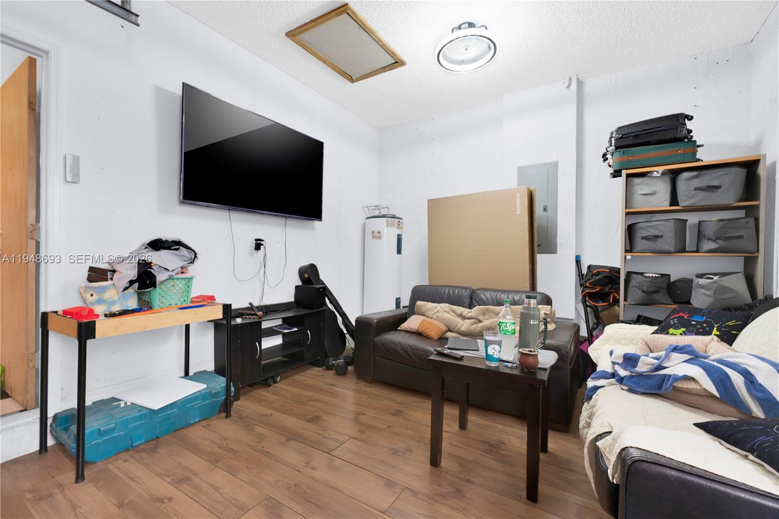 74 Northwest 2nd Street Homestead, FL 33030 - Photo 41 of 41 a living room with furniture and a flat screen tv