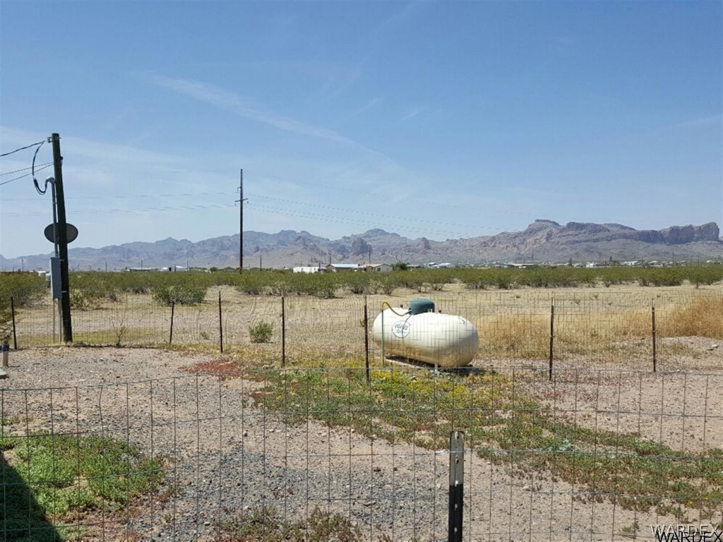 1097 South Concho Road Golden Valley, AZ 86413 - Photo 18 of 20 a view of a lake with a big yard