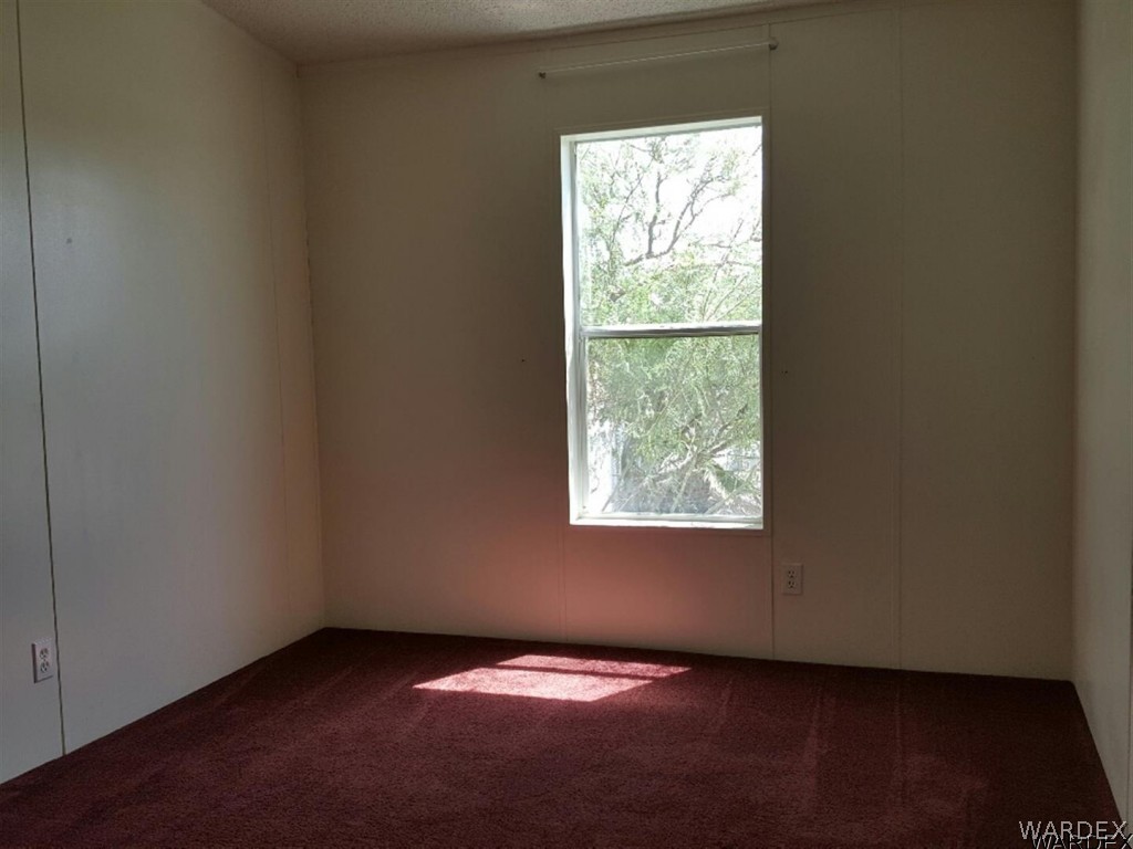 1097 South Concho Road Golden Valley, AZ 86413 - Photo 4 of 20 an empty room with a window