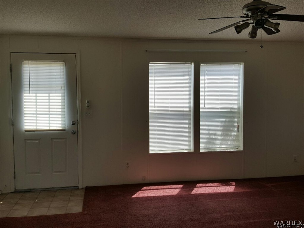 1097 South Concho Road Golden Valley, AZ 86413 - Photo 6 of 20 a view of an empty room with wooden floor and a window