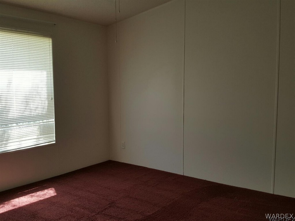 1097 South Concho Road Golden Valley, AZ 86413 - Photo 7 of 20 an empty room with a window