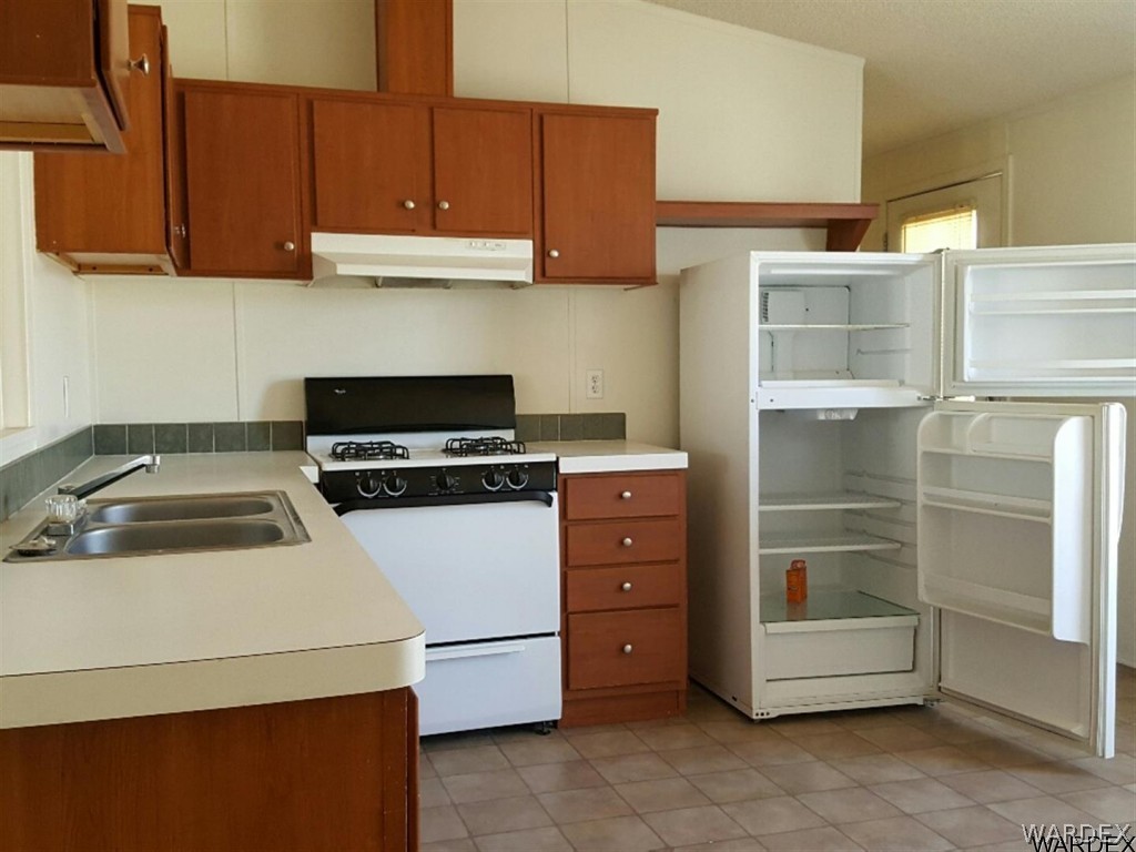 1097 South Concho Road Golden Valley, AZ 86413 - Photo 10 of 20 a kitchen with a cabinets and white stove