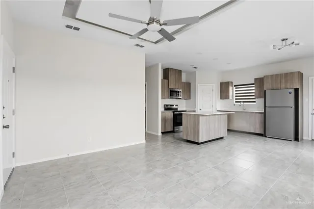a kitchen with stainless steel appliances a refrigerator and a stove top oven