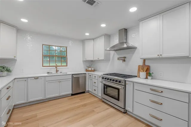 a kitchen with a stove oven and sink