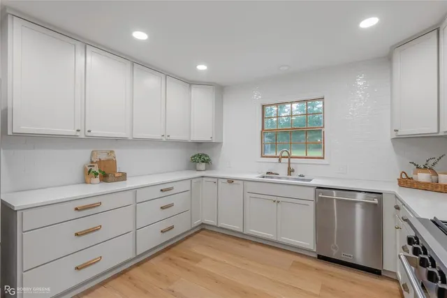 a kitchen with a sink window and cabinets