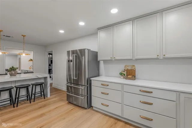 a kitchen with cabinets and stainless steel appliances