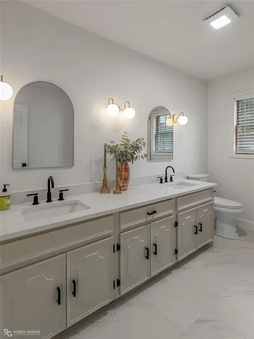 a bathroom with a double vanity sink and a mirror