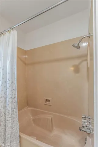 a bathroom with a shower and a bath tub