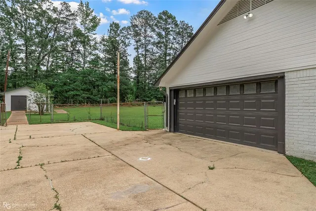 a backyard of a house with plants and outdoor seating