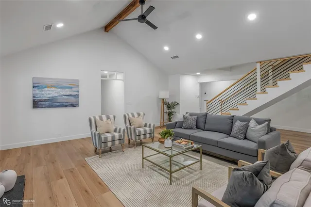 a living room with furniture and wooden floor