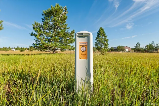 a sign board with an ocean in the back