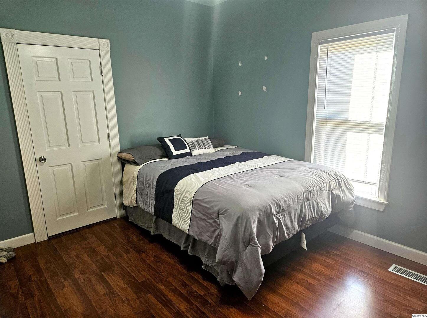 1520 Spruce Street Quincy, IL 62301 - Photo 11 of 21 a bed sitting in a bedroom next to a window