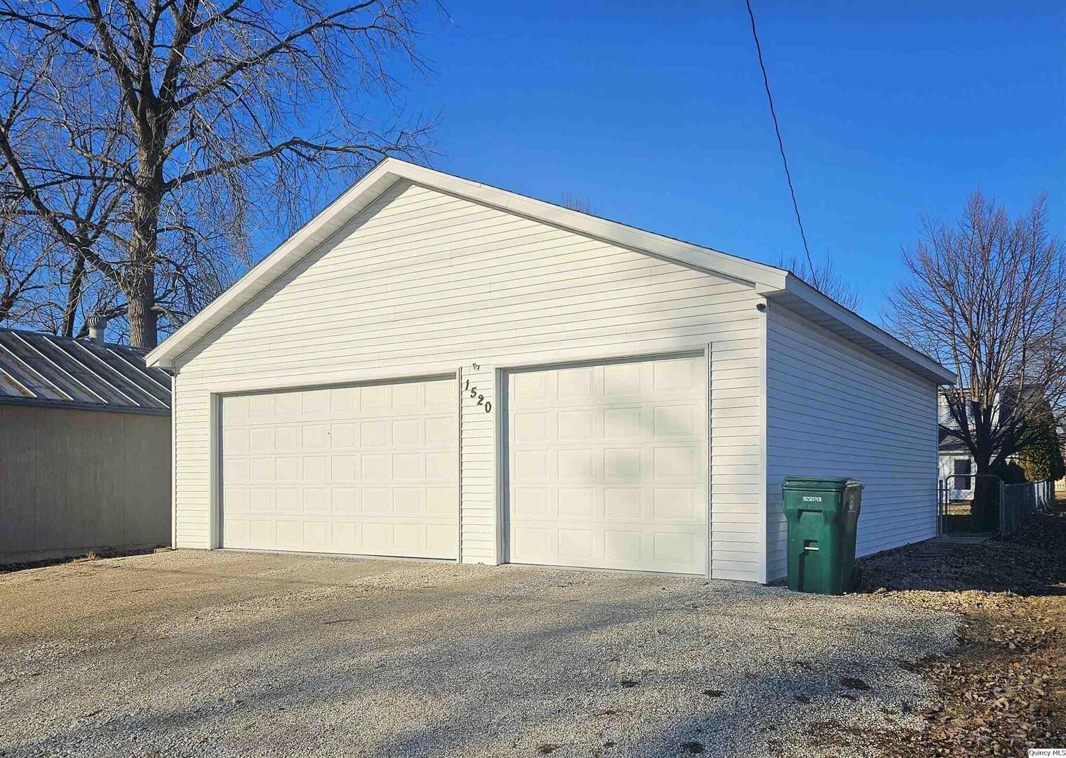 1520 Spruce Street Quincy, IL 62301 - Photo 18 of 21 a view of a house with a backyard and garage