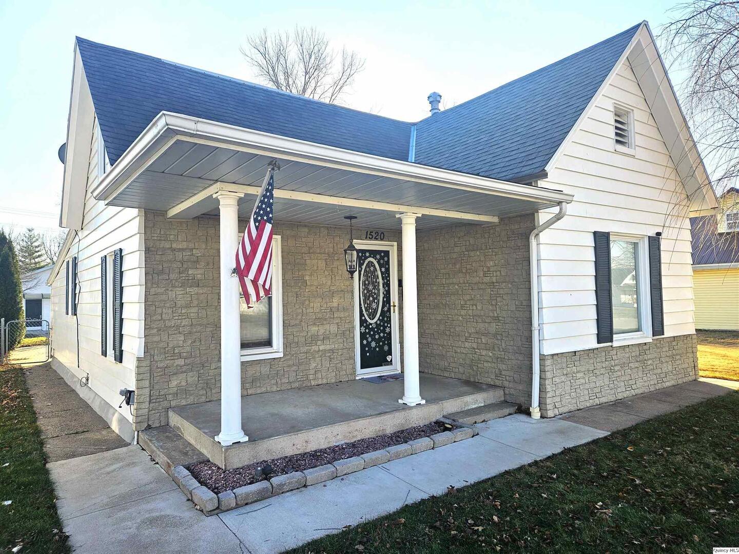 1520 Spruce Street Quincy, IL 62301 - Photo 2 of 21 a front view of a house with a garage