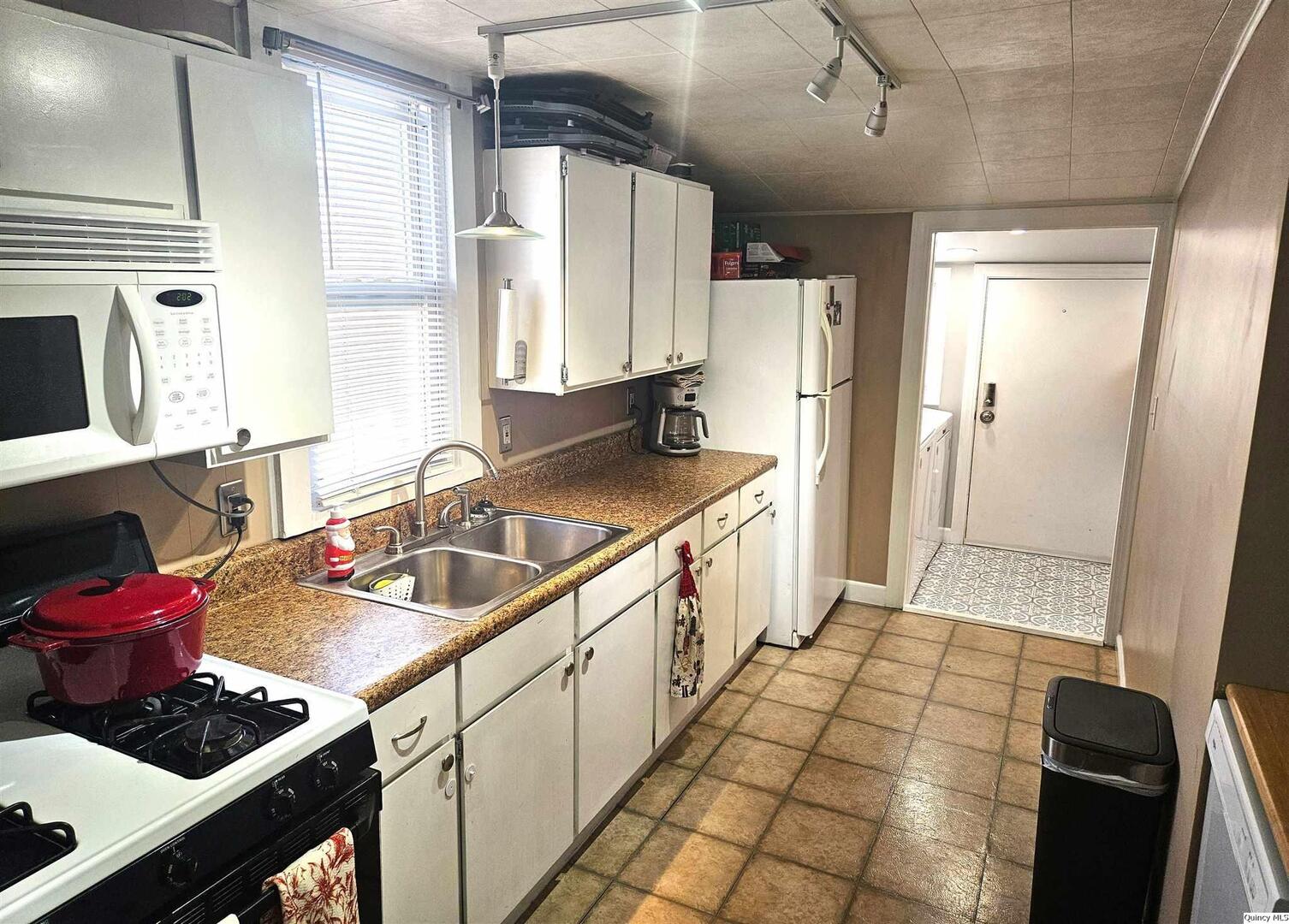 1520 Spruce Street Quincy, IL 62301 - Photo 7 of 21 a kitchen with sink cabinets and stove