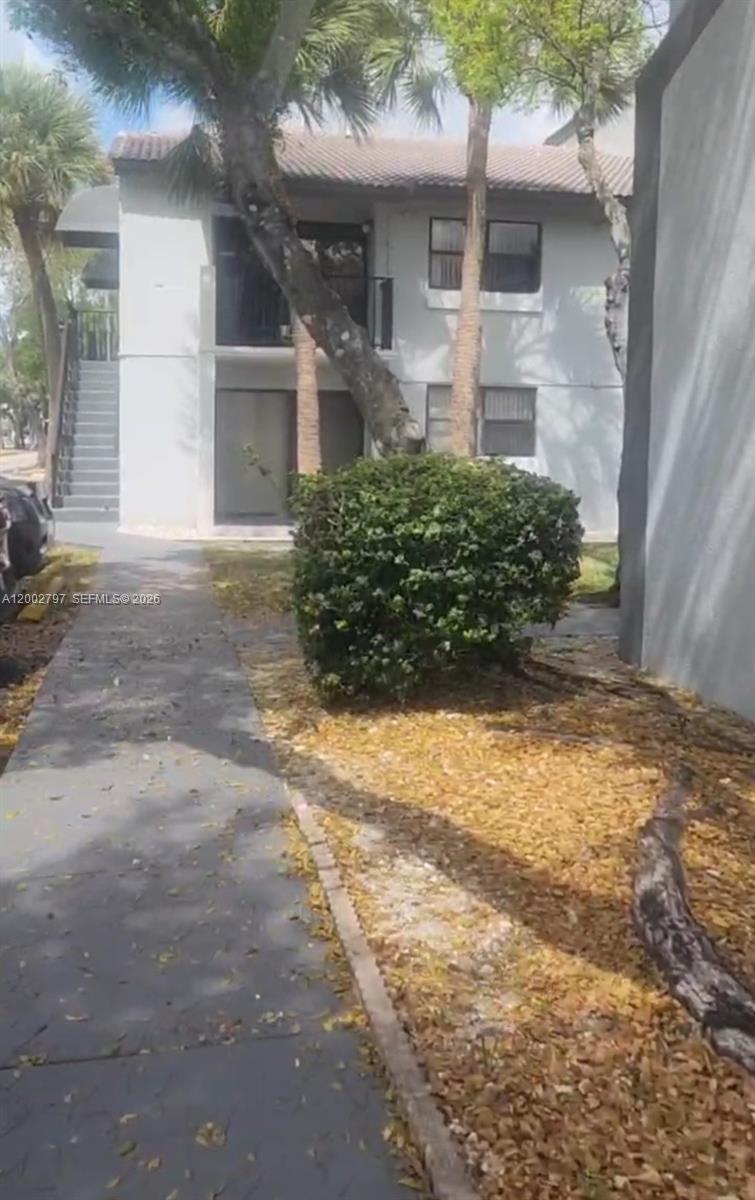 7220 Northwest 179th Street, Unit 111 Hialeah, FL 33015 - Photo 1 of 12 a view of backyard of house