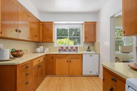 a kitchen with sink cabinets and window