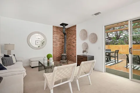 a living room with furniture a large window and a clock
