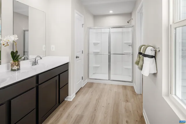 a bathroom with a double vanity sink and mirror
