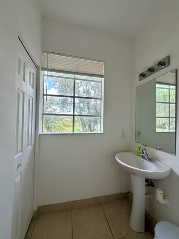 a bathroom with a sink toilet and a mirror