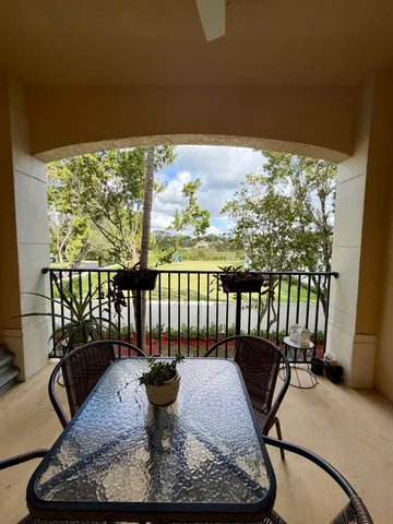 a view of a chairs and table in patio