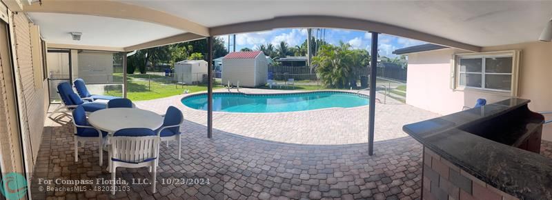 3322 Coolidge Street Hollywood, FL 33021 - Photo 29 of 32 a view of a dining room with furniture wooden floor and a chandelier
