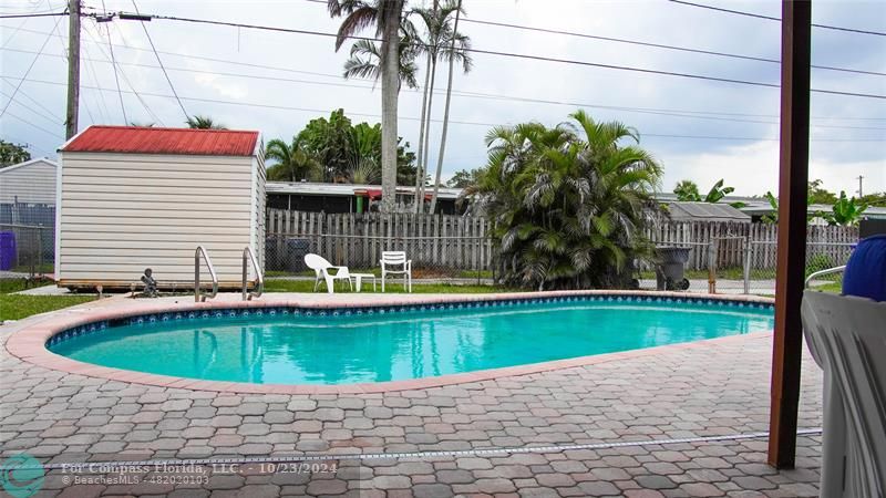3322 Coolidge Street Hollywood, FL 33021 - Photo 31 of 32 a view of a house with a swimming pool and a small yard