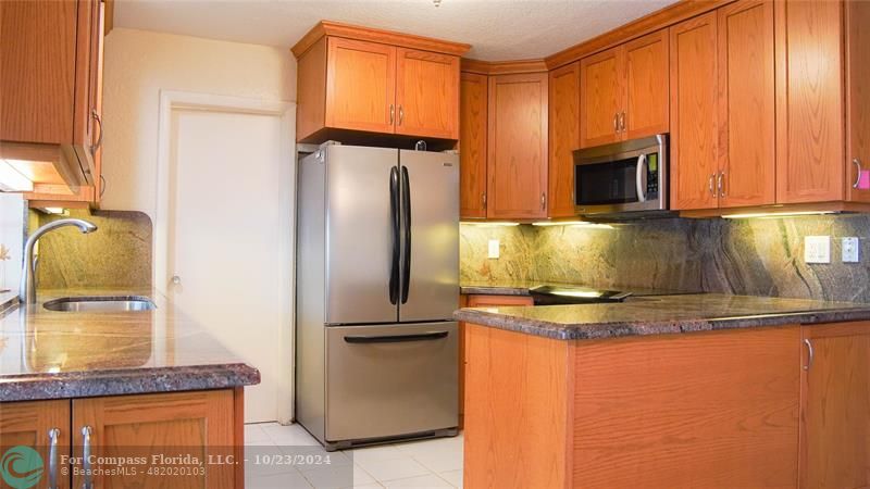3322 Coolidge Street Hollywood, FL 33021 - Photo 7 of 32 a kitchen with a refrigerator and a sink