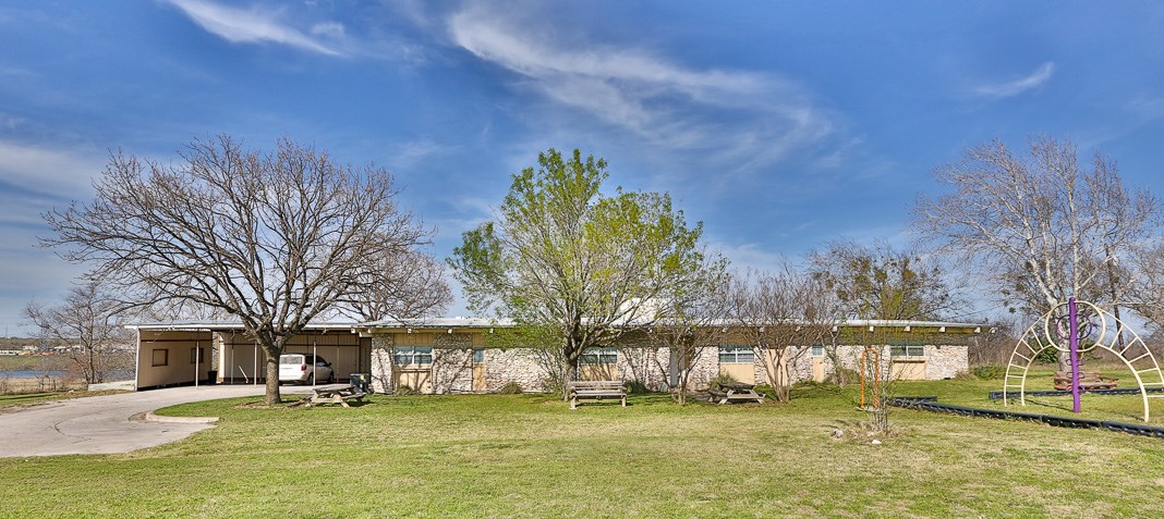 15401 Cameron Road Pflugerville, TX 78660 - Photo 1 of 1 a large building with trees in front of it
