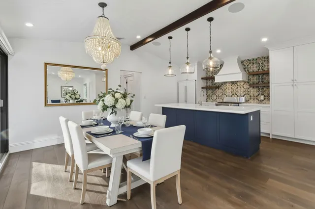 a view of a dining room with furniture wooden floor and chandelier