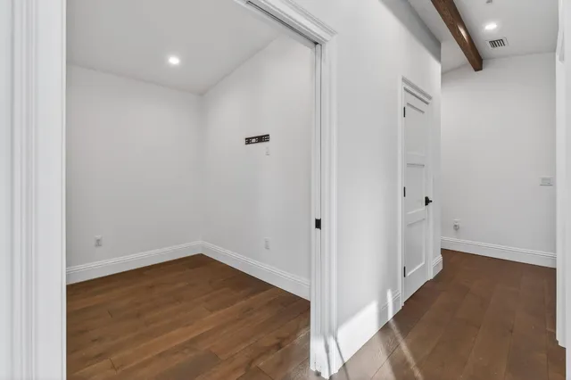 a view of a room with wooden floor