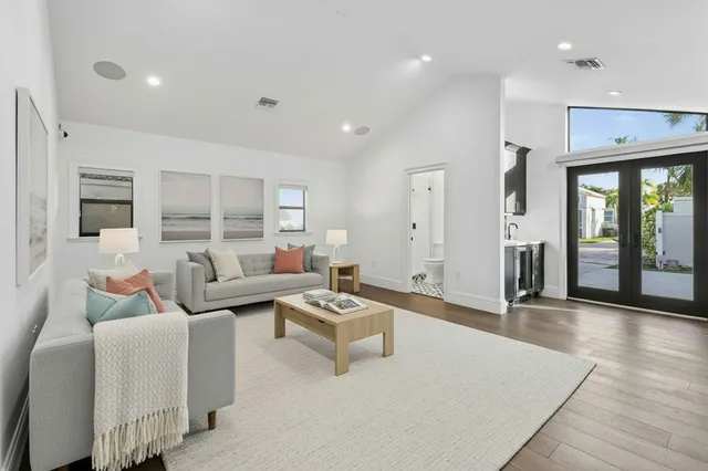 a living room with furniture and wooden floor
